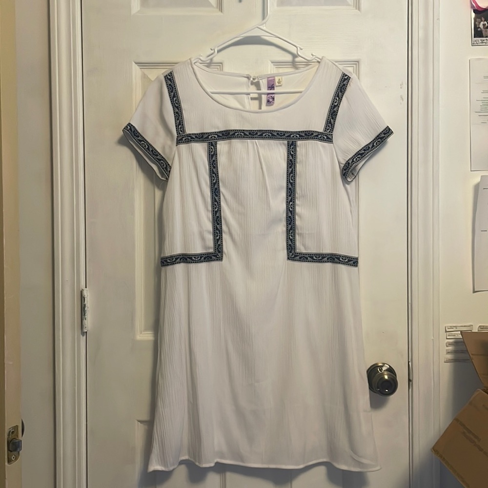 White dress with geometric ribbon detailing